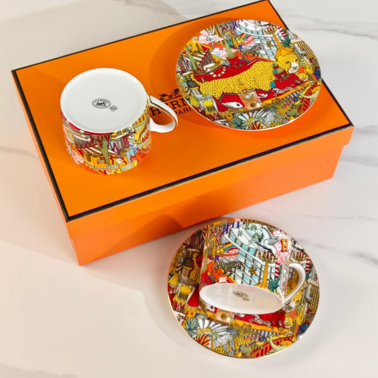 Hermes porcelain teacups and saucers with a "Forest Animals" pattern. Two cups.